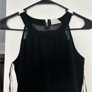 Black zip with mesh top and opening at the top romper.